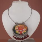 Hand-painted deer hasli necklace in silver replica finish with maroon bead drops from Khallaq Chand Collection.