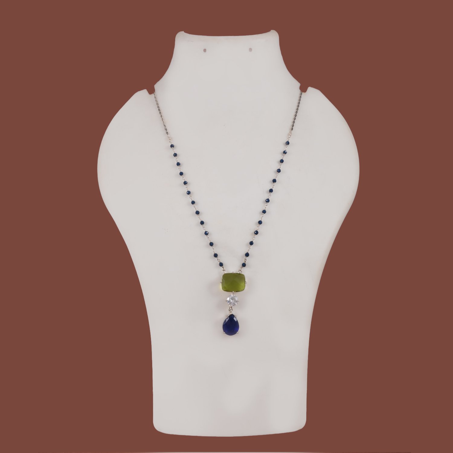 94 Silver replica chain pendant available in maroon, blue & light green, and purple stone variants from Khallaq Chand Collection.