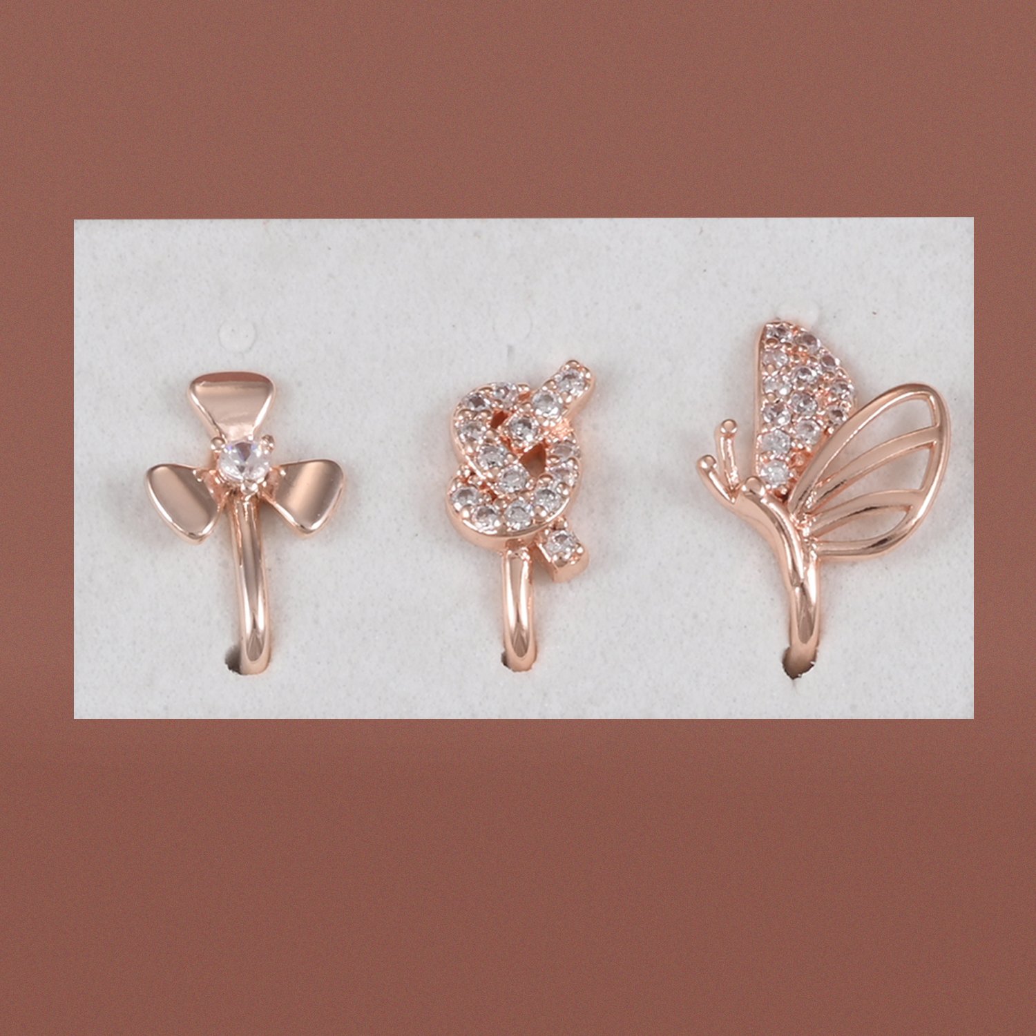 138 Saadgi anti tarnish rose gold non piercing nose pin combo pack of 3 with floral, infinity and butterfly designs by Khallaq.